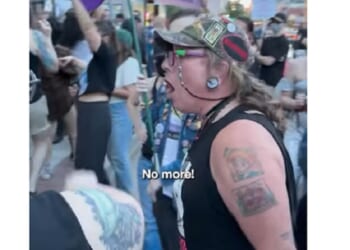 An activist screams outside the Drip Café in Denver. The Christian coffee shop is a perennial target of the militant transgender movement.