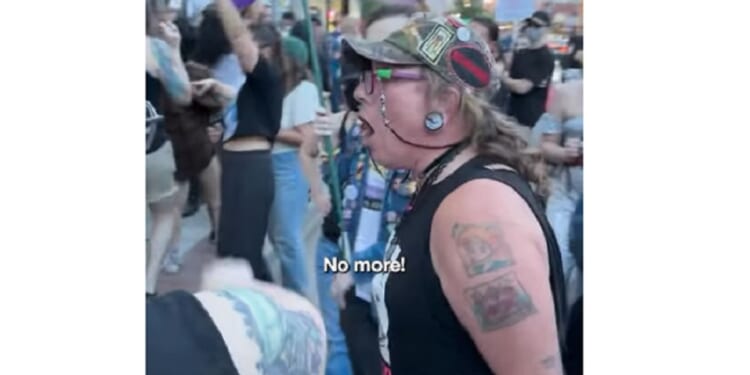 An activist screams outside the Drip Café in Denver. The Christian coffee shop is a perennial target of the militant transgender movement.