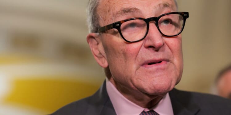 Senate Minority Leader Chuck Schumer stands in a hallway as he takes questions from the press on June 2, 2026.