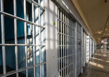 The sun shining on the bars of an historic prison.