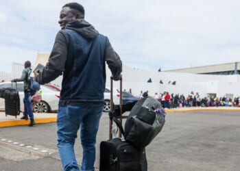 Lovenstar, a Haitian rap artist, joins hundreds of asylum seekers who used a CBP phone app to schedule an interview with U.S. agents at the San Ysidro Border Crossing in Tijuana, Mexico, on April 25, 2024.