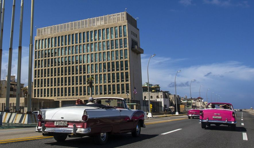 Tourists ride classic convertible cars on the Malecon beside the U.S. Embassy in Havana, Cuba, Oct. 3, 2017. The Pentagon confirms that a senior Defense Department official who attended last years’ NATO summit in Lithuania had symptoms similar to those reported by U.S. officials who have experienced “Havana syndrome." (AP Photo/Desmond Boylan, File)