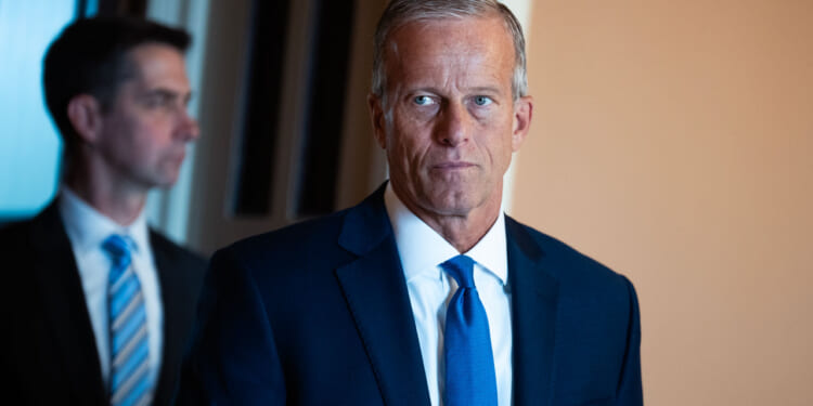 Senate Majority Leader John Thune walks through the Capitol.