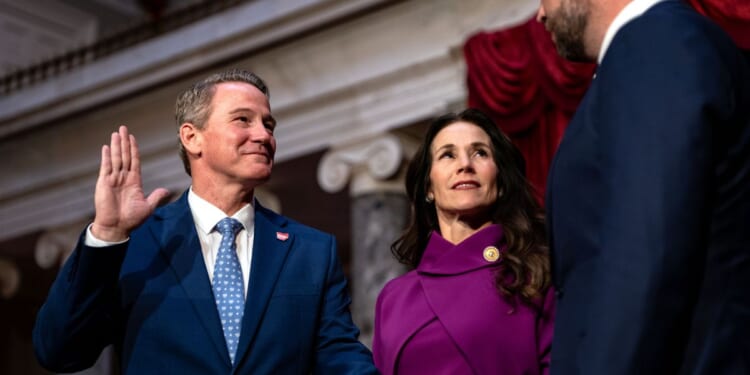 Sen. Jon Husted, as his wife Tina Husted looks on, is ceremonially sworn in by Vice President J.D. Vance in the Old Senate Chamber at the U.S. Capitol on Jan. 21, 2025, in Washington, D.C.