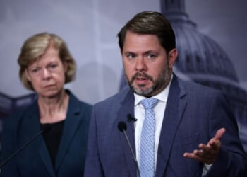 Sen. Tammy Baldwin listens as Sen. Ruben Gallego speaks during a news conference to introduce the Protect our Polls Act at the U.S. Capitol on June 18, 2026, in Washington, D.C.