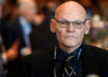 Democratic strategist James Carville stares out ahead of him while seated at a table.