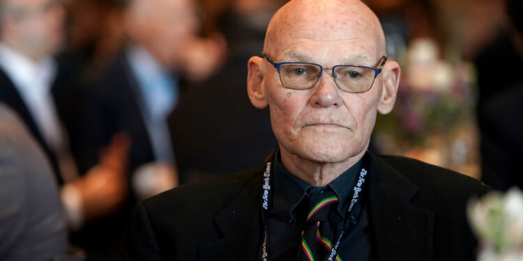 Democratic strategist James Carville stares out ahead of him while seated at a table.