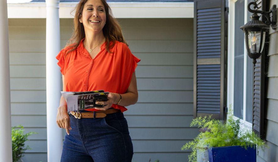 Melissa Hernandez, a Democratic candidate for Congress in California's 14th district, knocks on doors on Sunday, June 14, 2026 in Pleasanton, Calif. (AP Photo/Annie Barker )