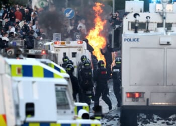 Protesters clash with police on Wednesday in Belfast, Northern Ireland, in unrest over an attack Monday on a man in the city by an "asylum seeker."