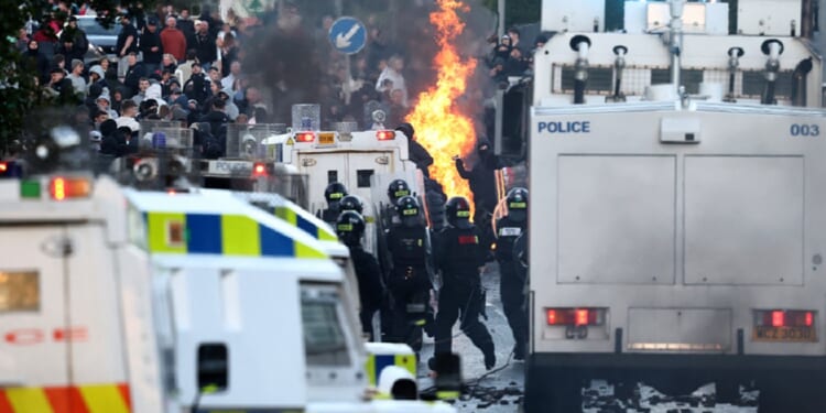 Protesters clash with police on Wednesday in Belfast, Northern Ireland, in unrest over an attack Monday on a man in the city by an "asylum seeker."