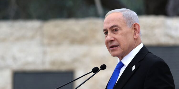 Israeli Prime Minister Benjamin Netanyahu speaks during a ceremony commemorating Israel's Remembrance Day for fallen soldiers, or Yom HaZikaron, at the Military Cemetery on Mount Herzl in Jerusalem on April 21, 2026.