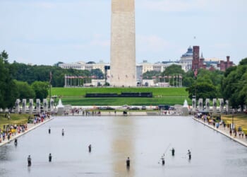 National Park Service personnel vacuum algae from the Reflecting Pool on June 21, 2026, in Washington, D.C.