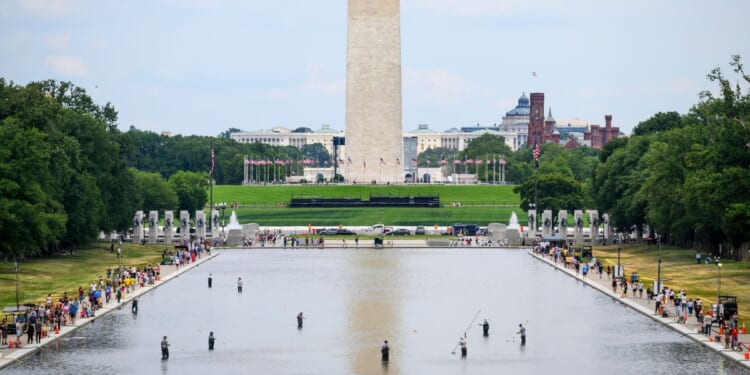 National Park Service personnel vacuum algae from the Reflecting Pool on June 21, 2026, in Washington, D.C.