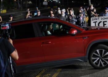 Protesters yell as a car enters Delaney Hall Immigration Detention Center on Tuesday in Newark, New Jersey.