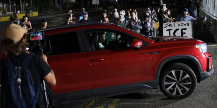 Protesters yell as a car enters Delaney Hall Immigration Detention Center on Tuesday in Newark, New Jersey.