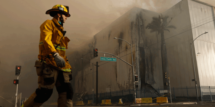 An LA City firefighter stands outside of the Boyle Heights warehouse fire.