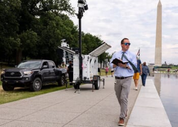 U.S. Park Police and contractors place security cameras along the Lincoln Memorial Reflecting Pool Thursday in Washington, D.C.