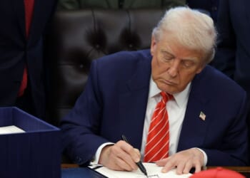 President Donald Trump signs a bill in the Oval Office of the White House on Feb. 3, 2026 in Washington.