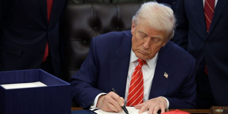 President Donald Trump signs a bill in the Oval Office of the White House on Feb. 3, 2026 in Washington.