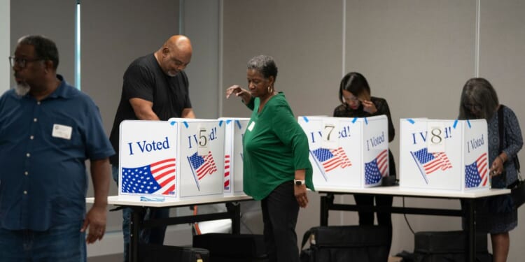 People fill out ballots on the first day of early voting at the County Voter Registration Office on May 26, 2026, in Columbia, South Carolina.