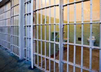 A row of locked prison cells.