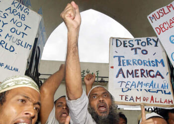 A group of angry anti-US protesters from the "Team of Allah" chant slogans calling for the death of US President George Bush in Dhaka, in 2002.
