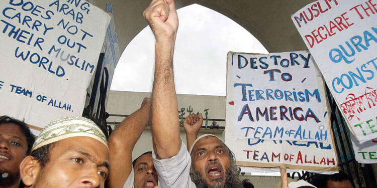 A group of angry anti-US protesters from the "Team of Allah" chant slogans calling for the death of US President George Bush in Dhaka, in 2002.
