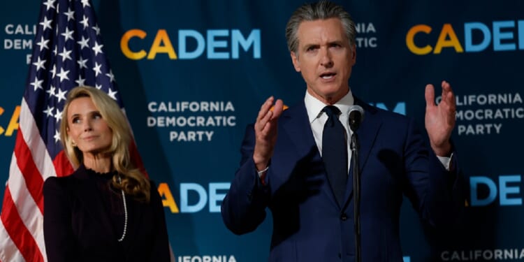 California Gov. Gavin Newsom and his wife, Jennifer Siebold Newsom, left, are pictured in a November file photo as election returns come in for a ballot measure that allowed California to redistrict its congressional delegation to elect more Democrats.