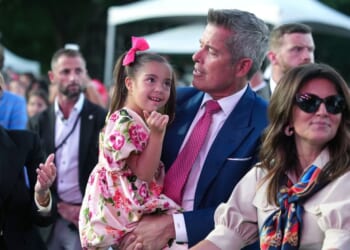 Secretary of Transportation Sean Duffy holds his daughter during a rally to kick off the Great American State Fair on the National Mall on June 24, 2026, in Washington, D.C.