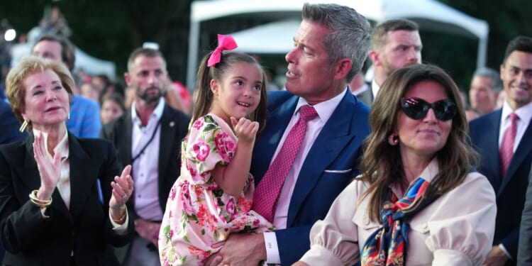 Secretary of Transportation Sean Duffy holds his daughter during a rally to kick off the Great American State Fair on the National Mall on June 24, 2026, in Washington, D.C.