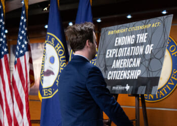 A congressional staffer sets up a posted on stage for Rep. Brian Babin's news conference on the Birthright Citizenship Act in the U.S. .Capitol on Thursday, January 23, 2025.