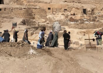 Workers walk through an archeological site in Egypt in February of 2018.