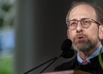 Harvard President Alan M. Garber speaking at a microphone