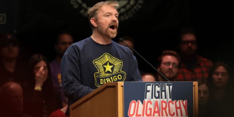 Democratic U.S. Senate candidate Graham Platner of Maine speaks at a “Fighting Oligarchy” tour stop held by Vermont Sen. Bernie Sanders May 24 in Orono, Maine.