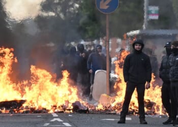 Youths gather in front of a burning barricade Wednesday in Belfast, Northern Ireland.