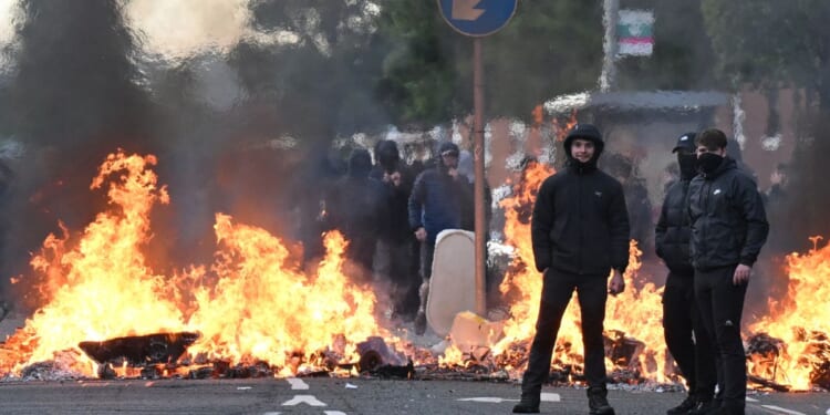 Youths gather in front of a burning barricade Wednesday in Belfast, Northern Ireland.