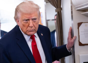 President Donald Trump speaks to reporters on Air Force One.