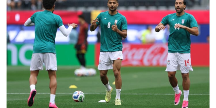 Mohammad Mohebi #8 of Iran warms up between Saman Ghoddos #14 and Ramin Rezaeian #23 Monday before the FIFA World Cup 2026 Group G match between Belgium and IR Iran at Los Angeles Stadium.