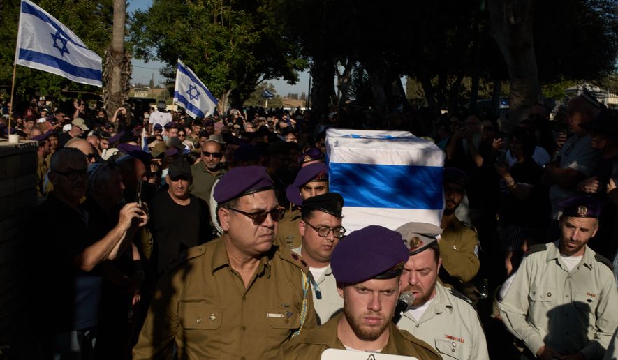Israeli soldiers carry the coffin of Staff-Sergeant Michael Tyukin, who was killed in a drone attack in southern Lebanon, during his funeral in Ashkelon, Israel, Monday, June 1, 2026. (AP Photo/Leo Correa)