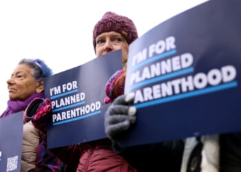 Protesters holding Planned Parenthood signs