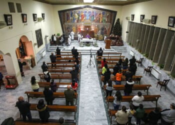 Worshippers pray in a Roman Catholic Church in Marka, east of Jordan's capital, on Dec. 13, 2020.