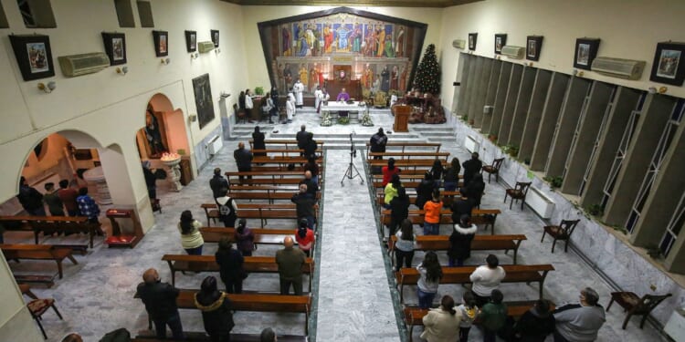 Worshippers pray in a Roman Catholic Church in Marka, east of Jordan's capital, on Dec. 13, 2020.