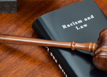 A gavel over a book tiled "Racism and Law."