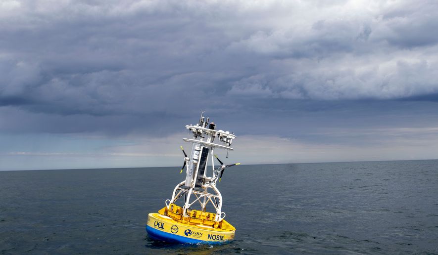 In this 2018 image provided by Woods Hole Oceanographic Institution, a buoy used to gather data floats in the Pioneer Mid-Atlantic Bight off the coast of North Carolina. (Darlene Trew Crist/Woods Hole Oceanographic Institution via AP)
