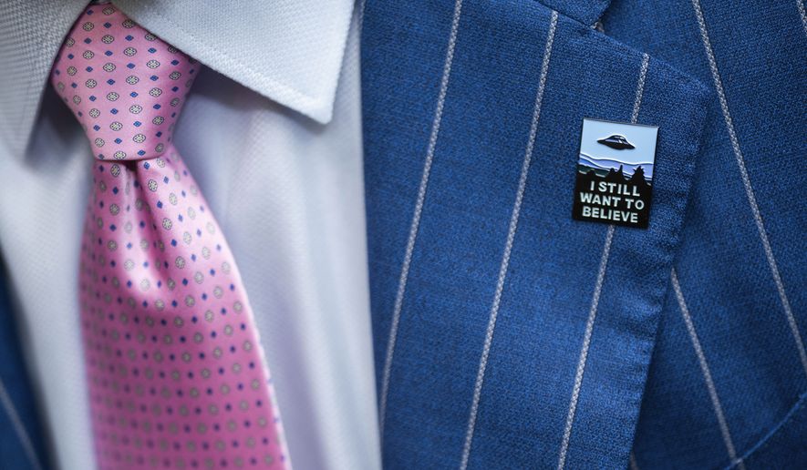 An audience member wears a UFO pin during a House Oversight and Accountability subcommittee hearing on UFOs, Wednesday, July 26, 2023, on Capitol Hill in Washington. (AP Photo/Nathan Howard)