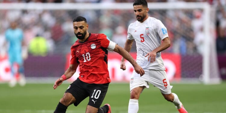 Mohamed Salah, playing for Egypt, and Milad Mohammadi, playing for Iran, play on a soccer field in Seattle, Washington on June 26, 2026.