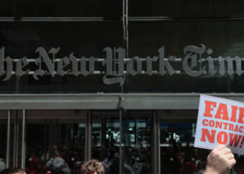Members of the New York Times Guild gather for a rally outside of the New York Times building on May 20, 2026 in New York City.