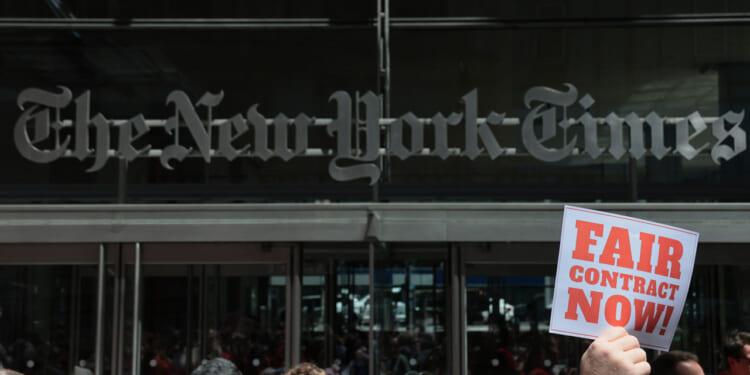 Members of the New York Times Guild gather for a rally outside of the New York Times building on May 20, 2026 in New York City.