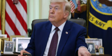 President Donald Trump prepares to sign an executive order during an event in the Oval Office of the White House on June 3 in Washington, DC. Trump signed executive orders related to strengthening customs enforcement and reforms to federal work laws. (Photo by Kevin Dietsch/Getty Images)