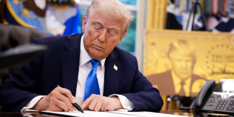 President Donald Trump signs an executive order in the Oval Office at the White House on Sept. 19, 2025. He signed a series of orders, one that tintroduced a $100,000 fee for H-1B visas. (Andrew Harnik/Getty Images)